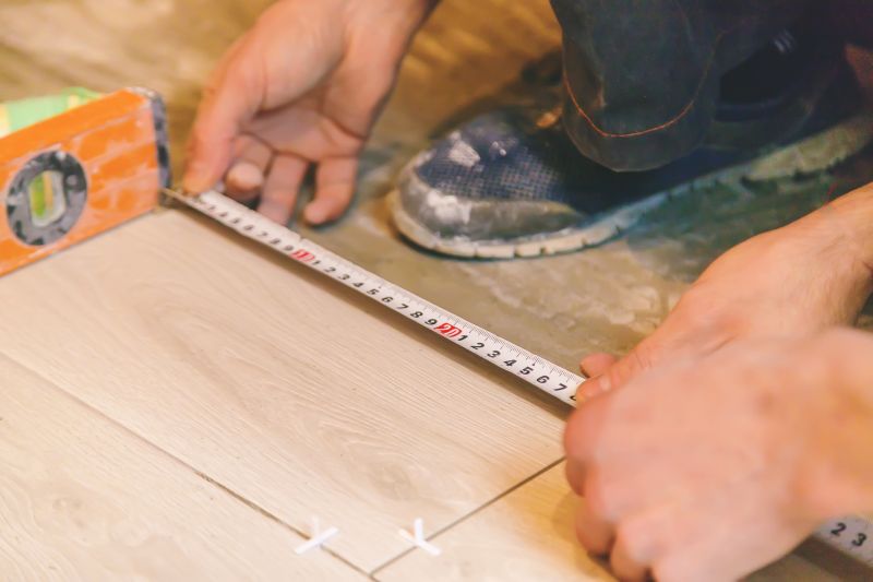 Professional tile installer measuring space